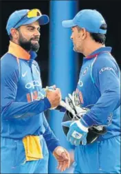  ?? AP PHOTO ?? Virat Kohli (left) feels MS Dhoni hasn’t got much opportunit­y to bat to rack up big scores.