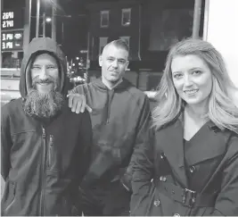  ?? ELIZABETH ROBERTSON / THE PHILADELPH­IA INQUIRER VIA AP ?? Kate McClure, right, and boyfriend Mark D’Amico have raised money for Johnny Bobbitt Jr., left, after he helped her.