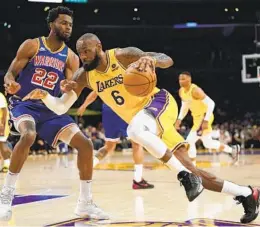  ?? ASHLEY LANDIS AP ?? Lakers forward Lebron James, who made 19 of 31 shots and 6 of 11 3s, drives against Warriors forward Andrew Wiggins during the first half Saturday.