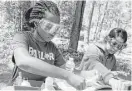  ?? Jason Fochtman / Houston Chronicle ?? Maggie Asare and Miya Gadeam test soil samples at William Goodrich Jones State Forest in Conroe.