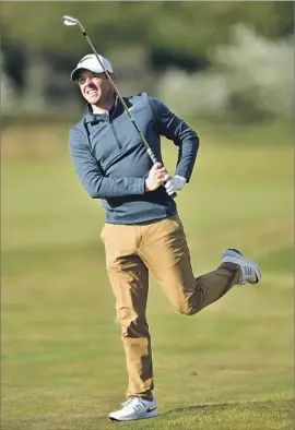  ?? Stuart Franklin Getty Images ?? AFTER MAKING BOGEYS on five of his first six holes, Rory McIlroy had more of a spring in his step on the back nine and finished with a one-over 71.