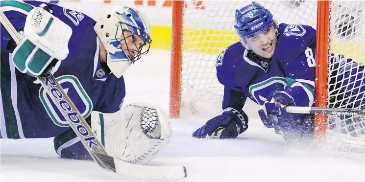  ?? GERRY KAHRMANN/PNG FILES ?? The Canucks’ Christophe­r Tanev and then-Vancouver goalie Roberto Luongo in action in 2012: “You knew he was always there,” Tanev says of Luongo.