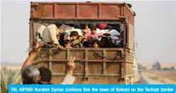  ?? TAL ABYAD: Kurdish Syrian civilians flee the town of Kobani on the Turkish border as Turkey and its allies continue their assault on Kurdish-held border towns in northeaste­rn Syria. ?? —AFP