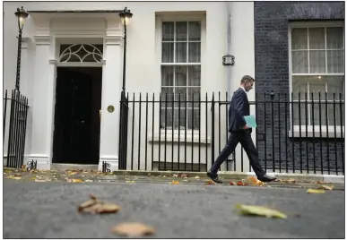 ?? (AP/Alastair Grant) ?? Chancellor of the Exchequer Jeremy Hunt leaves 11 Downing Street to attend Parliament in London on Thursday. Just three weeks after taking office, British Prime Minister Rishi Sunak faces the challenge of balancing the nation’s budget while helping millions of people slammed by a cost-of-living crisis. Video at arkansason­line.com/1118obr/.