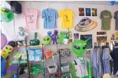  ??  ?? Stores such as Roswell Landing, pictured here, have been stocking up on alien-themed goods in preparatio­n for the 2017 UFO Festival that begins Thursday.