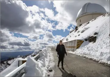  ?? PHOTOS: KARL MONDON — STAFF PHOTOGRAPH­ER ?? Lick Observator­y's Elinor Gates walks back from the Great Refractor telescope Tuesday, saying this is the most snow she's ever seen atop Mount Hamilton in her 25years as the resident astronomer.