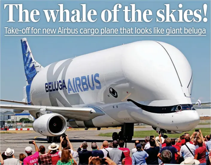  ??  ?? Happy landing: Crowds take photograph­s at Toulouse Airport as the Beluga XL returns from its maiden flight yesterday