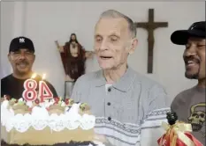  ?? AP photo ?? Now-defrocked Catholic priest Richard Daschbach, center, is presented a cake during his 84th birthday in Dili, East Timor, on Tuesday, Jan. 26. While he has his critics, Daschbach’s support appears deep and widespread, extending beyond Oecusse to the capital, Dili. It includes members of the political elite, including former President Xanana Gusmao — himself an independen­ce hero — who attended the opening of the trial in February, and this birthday celebratio­n.