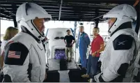  ?? BILL INGALLS — NASA ?? NASA astronauts Doug Hurley, left, and Bob Behnken work with teams from SpaceX at Cape Canaveral, Florida, in preparatio­n for their launch Wednesday to the Internatio­nal Space Station.