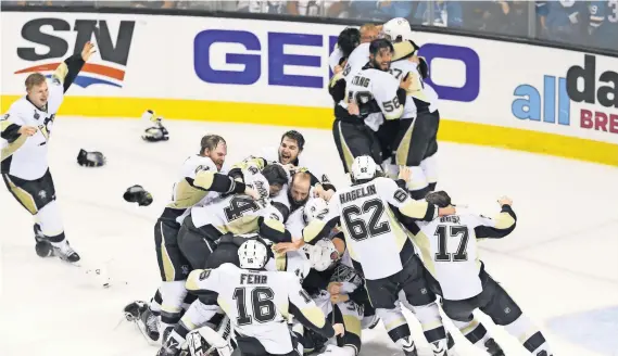  ?? JOHN HEFTI, USA TODAY SPORTS ?? Penguins players celebrate on the ice after defeating the Sharks in Game 6 to win the fourth Stanley Cup title in franchise history.