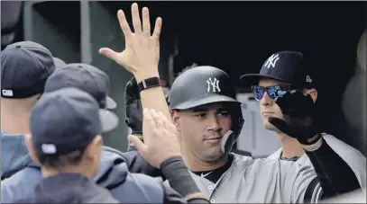  ?? Will Newton / Associated Press ?? New York’s Gary Sanchez, center, celebrates with teammates after hitting the first of his three home runs in the Yankees’ 15-3 win over the Baltimore Orioles on Sunday. New York hit seven homers Sunday, the most for the team in a road game since 1961.