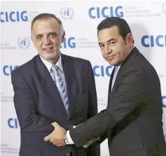  ??  ?? File photo shows Morales (right) shaking hands with Ivan Velasquez in Guatemala City on Oct 28, 2015. — Reuters photo