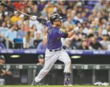  ?? Dustin Bradford, Getty Images ?? Rockies third baseman Nolan Arenado watches the flight of his fifth-inning solo home run against the Oakland Athletics on Friday night at Coors Field.
