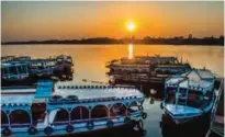  ?? — AFP photos ?? A picture shows river boats moored in the Nile at a marina during sunrise in the southern Egyptian city of Luxor.