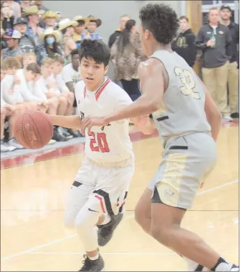  ?? RICK PECK/SPECIAL TO MCDONALD COUNTY PRESS ?? McDonald County’s Irael Marcos tries to get past Neosho’s Landon Austin during the Wildcats’ 52-40 win on Jan. 31 at MCHS.