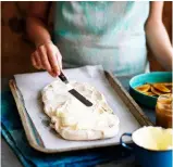  ??  ?? Step 7A Layering with cream
Assemble meringue. Spread cream using an offset spatula or the back of dessert spoon, leaving a border of meringue; top with the Dulce De Leche, then another meringue layer.