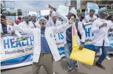  ?? — AFP ?? Kenyan doctors chant outside the health ministry headquarte­rs protesting to demand better pay and working conditions in the capital, Nairobi.