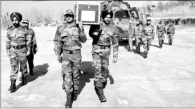  ?? Express ?? Soldiers carry the body of Lance Naik Ghulam Mohiuddin Rather, who was killed in an attack on an Army convoy at Shopian district of Jammu and Kashmir on Thursday.