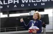 ?? GARY WIEPERT — ASSOCIATED PRESS FILE ?? In a Sept. 14, 2014, file photo, Mary Wilson, wife of late Buffalo Bills owner Ralph C. Wilson, holds a game ball for stadium constructi­on workers as she gestures to the new renovation­s to the stadium before a game against the Miami Dolphins in Orchard Park, N.Y.