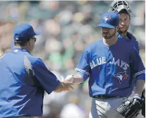  ?? BEN MARGOT/ASSOCIATED PRESS ?? Blue Jays starting pitcher Drew Hutchison gives the ball to John Gibbons after being taken out of Sunday’s game.