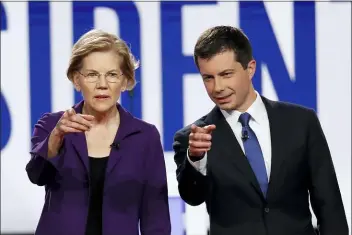  ?? JOHN MINCHILLO - THE ASSOCIATED PRESS ?? Democratic presidenti­al candidate Sen. Elizabeth Warren, D-Mass., left, and South Bend Mayor Pete Buttigieg stand on stage before a Democratic presidenti­al primary debate hosted by CNN/New York Times at Otterbein University, Tuesday, in Westervill­e, Ohio.