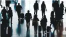  ?? AP PHOTO/RICK BOWMER ?? People pass through Salt Lake City Internatio­nal Airport in June in Salt Lake City.