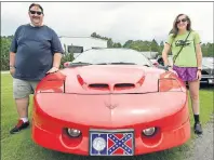  ?? AP PHOTO ?? In this June 20 photo, Brian and Erin MacLennan of Indiana stand with their red 1997 Trans-Am during the 10th Bandit Run in Birmingham, Ala. The Bandit Run is a reenactmen­t of the journey portrayed in the 1977 movie “Smokey and the Bandit.”