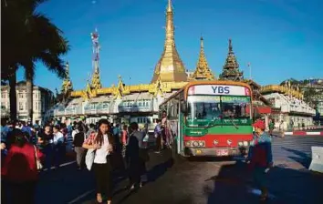  ?? AFP ?? A Yangon Bus Service vehicle is seen in Yangon yesterday. The service is expected to transform the lives of millions by bringing down the number of bus lines to 61 from some 300.