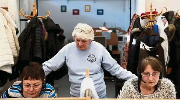  ??  ?? Still the head: A 65-year-old pensioner Zsoka Farkas works in a call centre as a team leader in Miskolc, Hungary.