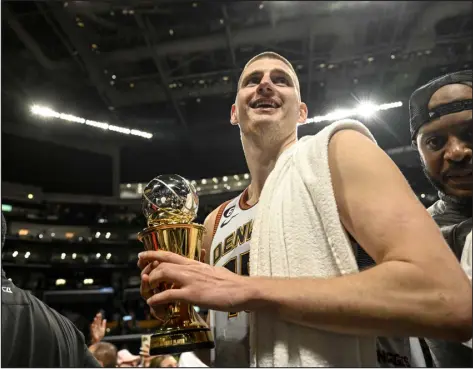  ?? AARON ONTIVEROZ — THE DENVER POST ?? Denver’s Nikola Jokic leaves the floor with his MVP trophy in hand after the the Nuggets’ 113-111 Western Conference Finals Game 4 win over the Los Angeles Lakers at Crypto.com Arena in Los Angeles on Monday.