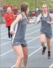  ?? Scott Herpst ?? Heritage’s Allie Mifflin passes the baton to Gracey Mccoy to start the second leg of the 4x800 relay at Dalton High School last week.