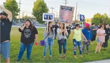  ??  ?? Demonstrat­ors held Carlos Saldana’s picket signs outside a community concert in Wilmington in 2019. Photo by Robin Doyno