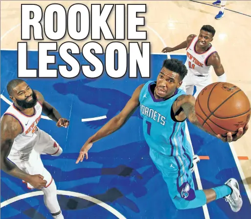  ?? Getty Images ?? FLYING HORNET: Hornets rookie Malik Monk — who many Knicks fans wanted the team to pick in this year’s draft — soars to the hoop past Frank Ntilikina (the player they did take) and Kyle O’Quinn during Charlotte’s 118-113 loss Tuesday at the Garden.