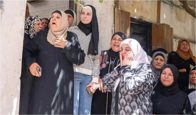  ?? Agence France-presse ?? ↑
Women react during the funeral of Palestinia­n Saleh Sabr in the Asker refugee camp east, West Bank, on Monday.