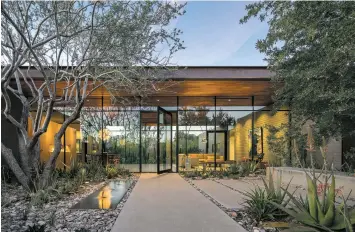  ?? BILL TIMMERMAN/WEDDLE GILMORE VIA AP ?? This photo provided by Weddle Gilmore Black Rock Studio shows the entry courtyard of a residence located in Paradise Valley, Ariz.