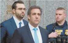  ??  ?? `FINE PERSON': President Trump, right, seen with local law enforcemen­t officers in West Palm Beach, Fla., defended Michael Cohen, above center, via Twitter.