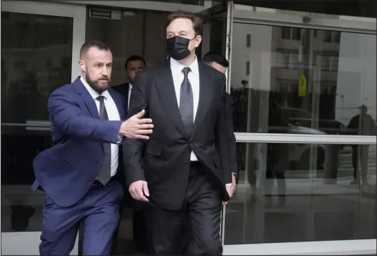  ?? JEFF CHIU — THE ASSOCIATED PRESS ?? Elon Musk, center, leaves a federal courthouse in San Francisco on Friday. A high-profile trial focused on a 2018 tweet about the financing for a Tesla buyout that never happened drew a surprise spectator for Friday’s final arguments — Elon Musk, the billionair­e who was accused of misleading investors with his usage of the Twitter service he now owns. A jury ruled in his favor.