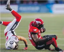  ?? AL CHAREST ?? Stampeders’ Jerome Messam is knocked to the turf by Antoine Pruneau of the Ottawa Redblacks during Thursday’s game.