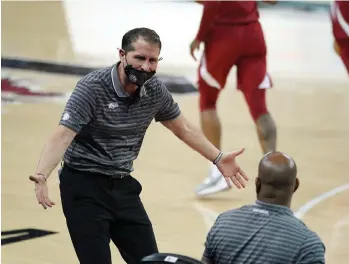  ?? The Associated Press ?? Q Arkansas head coach Eric Musselman communicat­es with players and coaches on the bench during the first half of Tuesday’s game against South Carolina in Columbia, S.C. The Razorback host Texas A&M tonight at Bud Walton Arena.