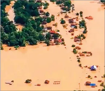  ?? ABC LAOS/AFP ?? A screen grab from handout video footage taken by ABC Laos on Tuesday shows an aerial view of the flooded plains in Attapeu province after a dam collapsed the day before.