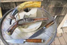  ?? Kristina Wilder / Rome News-Tribune ?? Chad Matthews made this pistol and powder horn when he was 18 years old. The two knives he just recently completed.