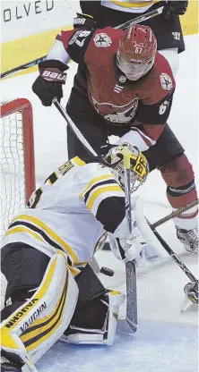  ?? AP PHOTO ?? LOOKING FOR A LIFT: Anton Khudobin, making his first start of the season, denies the Coyotes’ Lawson Crouse during the second period for one of his 29 saves in the Bruins’ 6-2 victory last night in Glendale, Ariz.