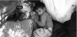  ?? PHOTO: REUTERS ?? A child, who fled his home because of the fighting between the Taliban and Afghan security forces, sleeps in a public park that is used as a shelter in Kabul