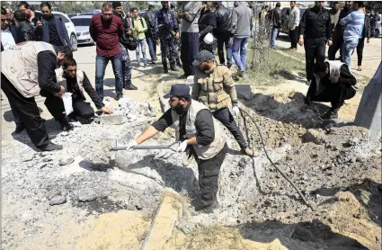  ?? PICTURE: AP ?? Hamas security officers inspect the explosion site where the convoy of Palestinia­n Prime Minister Rami Hamdallah entered Gaza through the Erez crossing with Israel, at the main road in Beit Hanoun, Gaza Strip, yesterday. His Fatah party called it an...