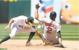  ?? Thearon W. Henderson / Getty Images ?? Boston’s Xander Bogaerts steals second base, beating the throw to A’s shortstop Adam Rosales in the fifth inning. It was one of four stolen bases in the game for the Red Sox.