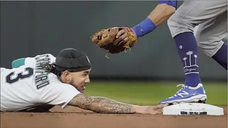  ?? Ted S. Warren Associated Press ?? THE MARINERS’ J.P. Crawford is tagged out by Dodgers second baseman Chris Taylor on an attempted steal during the second inning.