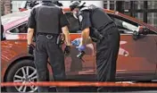  ?? ABEL URIBE/CHICAGO TRIBUNE ?? Police survey a car Saturday at St. Bernard Hospital after a mother and child were shot on Halsted Street.