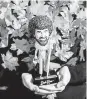  ??  ?? A Bob Ross bobblehead was given out to winners of a costume contest during the opening day of the “Bob Ross Experience.”