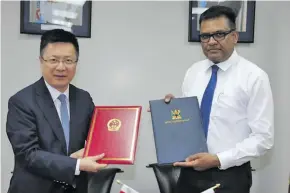  ?? Photo: Xinhua ?? Chinese Ambassador to Fiji Qian Bo (left) and the Permanent Secretary inr the Office of the Prime Minister, Yogesh Karan, after the signing ceremony in Suva on November 12, 2018.