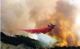  ?? AP PHOTOS/RINGO H.W. CHIU ?? An air tanker drops retardant on a wildfire in Goleta, Calif., last week.